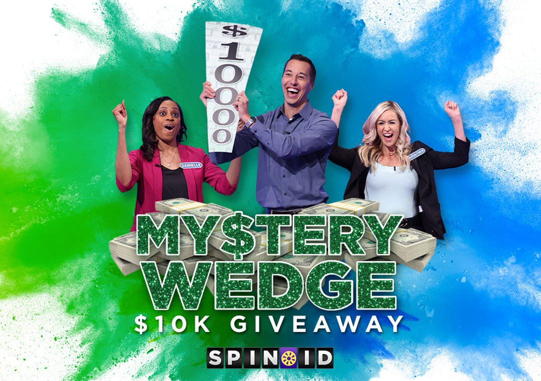 Contestant holding up a 10k wedge with a pile of money.  "Mystery $10K Giveaway Spin ID"