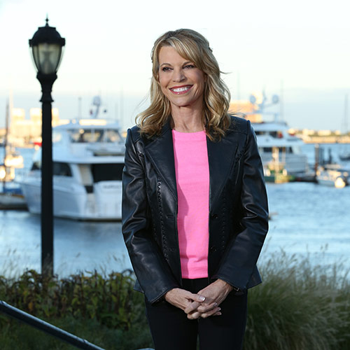 Vanna White in a pink shirt and leather jacket. 